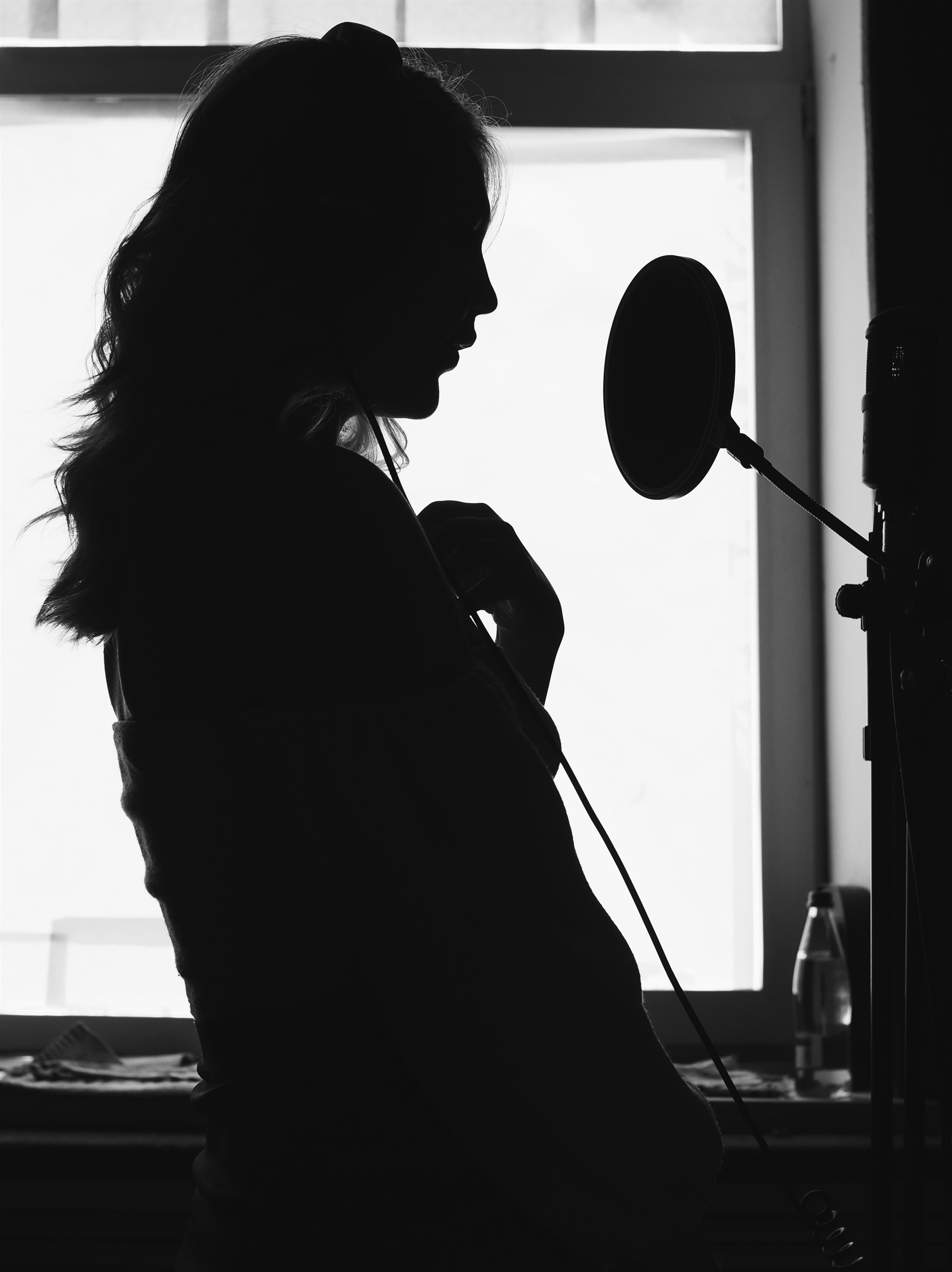 Recording artist performing at a studio microphone